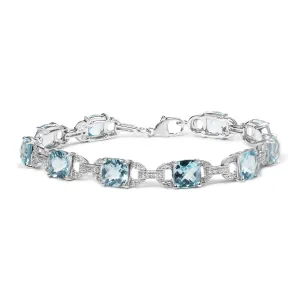 .925 Sterling Silver 7x7 mm Cushion Cut Blue Topaz and 1/20 cttw Round Cut Diamond Fashion Tennis Bracelet